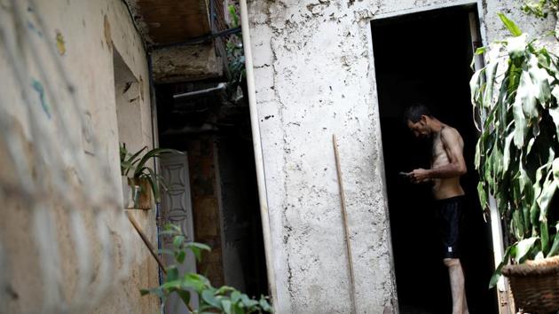 Jorge Perez looks at a phone in his mother’s home. Growing malnutrition is one of the reasons opposition leader Juan Guaido moved ahead with his plans to bring supplies of food and medicine into Venezuela by land and sea last Saturday, despite resistance from Maduro, who denies there is a humanitarian crisis and has said it was a “show” to undermine him. (Carlos Garcia Rawlins / REUTERS) Jorge Perez looks at a phone in his mother’s home. Growing malnutrition is one of the reasons opposition leader Juan Guaido moved ahead with his plans to bring supplies of food and medicine into Venezuela by land and sea last Saturday, despite resistance from Maduro, who denies there is a humanitarian crisis and has said it was a “show” to undermine him. (Carlos Garcia Rawlins / REUTERS)