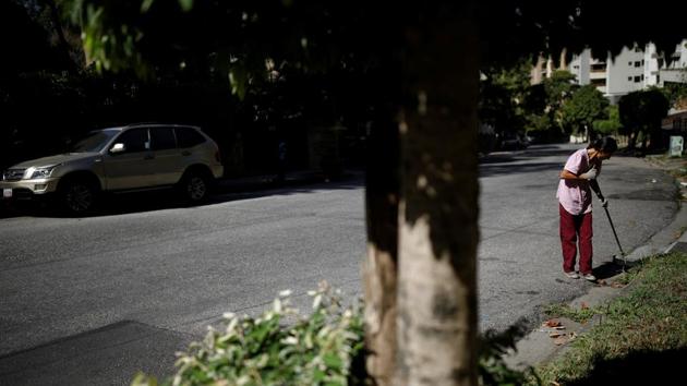Yaneidi Guzman works as a street sweeper. “I hope they let the aid in,” said Guzman, who despite holding down two jobs cannot make enough money for the tests, supplements or protein-rich diet that doctors have prescribed her. She and her husband make less than $30 per month and prioritize feeding their three young children. (Carlos Garcia Rawlins / REUTERS) Yaneidi Guzman works as a street sweeper. “I hope they let the aid in,” said Guzman, who despite holding down two jobs cannot make enough money for the tests, supplements or protein-rich diet that doctors have prescribed her. She and her husband make less than $30 per month and prioritize feeding their three young children. (Carlos Garcia Rawlins / REUTERS)