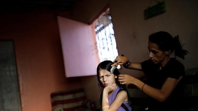 Yaneidi Guzman combs her daughter’s hair. Guzman dreams of living once more not off foreign aid or government handouts but her own work. “It’s not that I want to be rich, or a millionaire,” she said. “But I do want to give my children a good future, to make sure I can take them to the doctors when they get ill ... and that they eat well.” (Carlos Garcia Rawlins / REUTERS) Yaneidi Guzman combs her daughter’s hair. Guzman dreams of living once more not off foreign aid or government handouts but her own work. “It’s not that I want to be rich, or a millionaire,” she said. “But I do want to give my children a good future, to make sure I can take them to the doctors when they get ill ... and that they eat well.” (Carlos Garcia Rawlins / REUTERS)