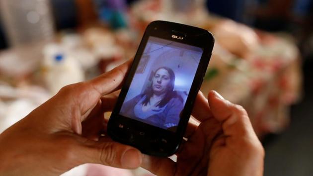 Yaneidi Guzman, holds up an old picture of herself on her phone, at home in Caracas. The United Nations and Red Cross have cautioned against the politicization of aid. The United States, which is pushing Maduro to step down, sent aid for Venezuela to a collection point in neighbouring Colombia in military aircraft, in a show of force. (Carlos Garcia Rawlins / REUTERS) Yaneidi Guzman, holds up an old picture of herself on her phone, at home in Caracas. The United Nations and Red Cross have cautioned against the politicization of aid. The United States, which is pushing Maduro to step down, sent aid for Venezuela to a collection point in neighbouring Colombia in military aircraft, in a show of force. (Carlos Garcia Rawlins / REUTERS)