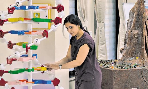 A staff member of the Science park department of SPPU prepares a DNA model on Tuesday, ahead of the event.(Milind Saurkar/HT Photo)