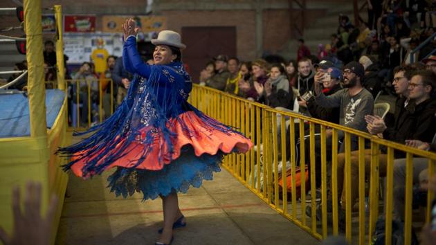 Veteran cholita wrestler Leydi Huanca dances as she enters the ring area to compete in El Alto. The group of competitors has gradually dwindled over time to just seven. Among the most famous is Reyna Torrez, the ring name of Leydi Huanca, who has entertained spectators for a dozen years, her moves inspired by Mexican wrestlers such as Rey Mysterio. (Juan Karita / AP) Veteran cholita wrestler Leydi Huanca dances as she enters the ring area to compete in El Alto. The group of competitors has gradually dwindled over time to just seven. Among the most famous is Reyna Torrez, the ring name of Leydi Huanca, who has entertained spectators for a dozen years, her moves inspired by Mexican wrestlers such as Rey Mysterio. (Juan Karita / AP)