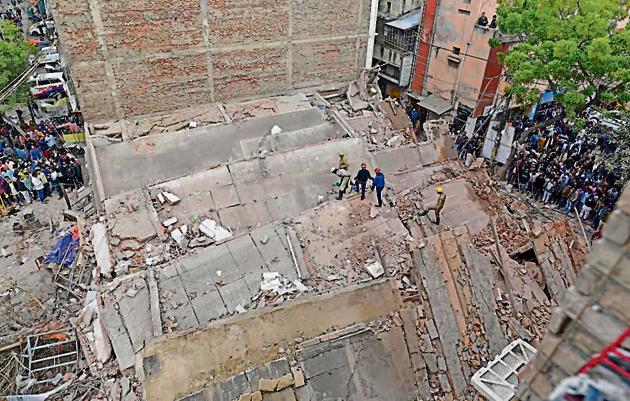 Police said there were no casualties in Wednesday’s incident but local residents said a 50-year-old woman living in an adjacent building fell and hurt her head while scampering to safety.(Sanchit Khanna/HT Photo)