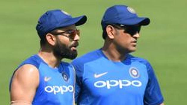 Indian cricket team's captain Virat Kohli (L) with Mahendra Singh Dhoni attend a training session.(AFP)