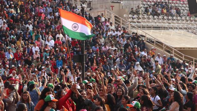 Spectators wave Tricolour during Beating Retreat ceremony at Attari-Wagah border, near Amritsar,  on Tuesday, February 26, 2019. (Sameer Sehgal / HT Photo)