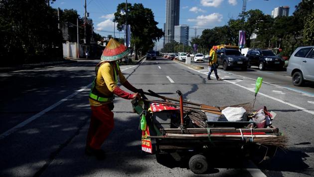 Alejandro Galasao pushes a cart with cleaning supplies at Quezon Avenue in Quezon City. Traffic is so bad in Manila that if he leaves any later, there’s no way he will clock in on time. “If I go to work at rush hour, it would take me three hours,” Galasao told Reuters. “This is the only job I know. Even if I find something else, I doubt I would earn any better.” (Eloisa Lopez / REUTERS)