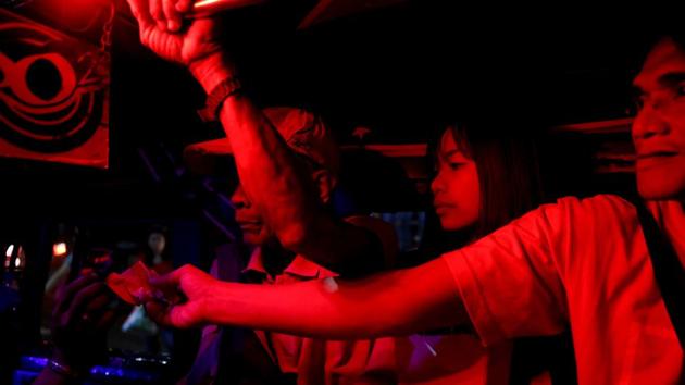 Janice Sarad (C), 22, who works for a bank, sits inside a jeepney in Pasig City, Metro Manila, Philippines. “You have to push, shove, and run because everyone’s trying to get a seat. On the train, everyone tries to sneak on so they don’t have to wait. On the bus, there are usually no seats so you stand up the whole ride,” she said. (Eloisa Lopez / REUTERS)