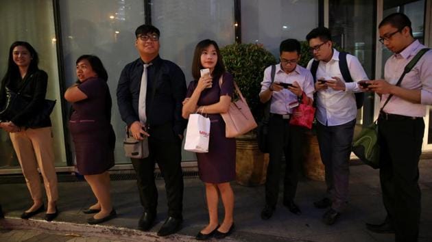 Janice Sarad queues for her company’s free shuttle service going to the train station, in Taguig City. On a regular day she takes a train, a bus and two passenger jeeps to get to work. When Sarad doesn’t work overtime, she opts to take the free shuttle service to save money. (Eloisa Lopez / REUTERS)
