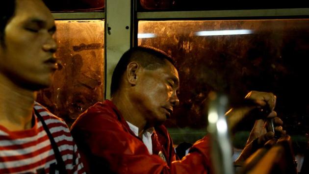 Alejandro Galasao sleeps on a bus going to work. He has to wake up in the middle of the night for a job that doesn’t start until 6 a.m. Galasao only gets four to five hours of sleep each day. “To be honest, there's really not enough time to sleep. The earliest time I get to sleep is 20:00, sometimes 21:00 and then I have to wake up at 01:00.” (Eloisa Lopez / REUTERS)