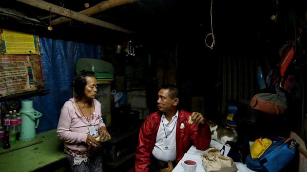 Alejandro Galasao eats breakfast with his wife in their home in San Jose Del Monte City. It’s 3.30 a.m. and much of the city is fast asleep. Flashlight in hand, street sweeper Galasao, 58, navigates a labyrinth of alleys to a main road to catch a bus to the capital Manila 30 km away. (Eloisa Lopez / REUTERS)