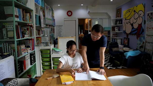 Ferdinand Tan observes his daughter who is homeschooled in Cainta City. Tan and his wife decided to homeschool their children to maximise their hours every day. “I don’t want them to spend so much unproductive time travelling every single day. That’s time away from the family. And by the time they get home, they’re already tired.” (Eloisa Lopez / REUTERS)