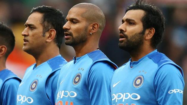 MS Dhoni, Shikhar Dhawan and Rohit Sharma of India sing the national anthem ahead of a match.(Getty Images)