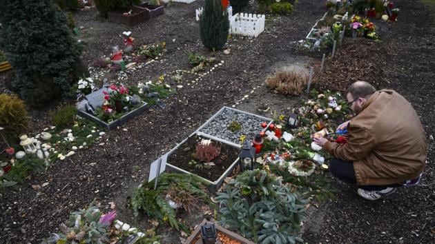 A visitor lights a candle on the grave of his pet. Sebastian Oehlandt said he goes to the cemetery two or three times a week to spend time at the small tomb of his cat of almost 15 years, Hiro. “Suddenly, there was this massive hole,” he said, recalling the day when Hiro died just before Christmas. “I needed time for me,” said the 27-year-old, who lives with his father and another cat. (John MacDougall / AFP) A visitor lights a candle on the grave of his pet. Sebastian Oehlandt said he goes to the cemetery two or three times a week to spend time at the small tomb of his cat of almost 15 years, Hiro. “Suddenly, there was this massive hole,” he said, recalling the day when Hiro died just before Christmas. “I needed time for me,” said the 27-year-old, who lives with his father and another cat. (John MacDougall / AFP)