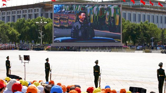 A screen displays Chinese President Xi Jinping reviewing the army at the Tiananmen Square, at the beginning of the military parade.(Reuters Photo)