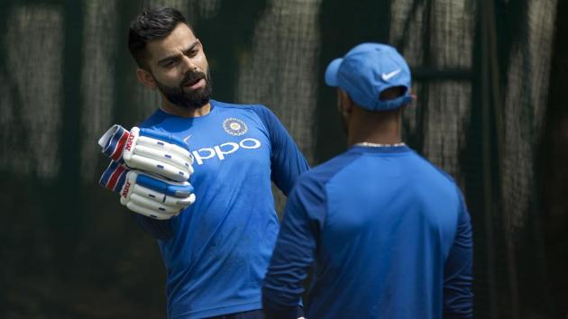 Virat Kohli, left, talks to Shikhar Dhawan during a practice session.(AP)