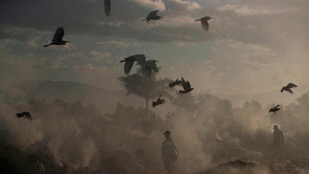 Locals walk among burning rubbish piles at the main garbage dump near Cite Soleil neighbourhood in Port-au-Prince, Haiti. (Ivan Alvarado / REUTERS) Locals walk among burning rubbish piles at the main garbage dump near Cite Soleil neighbourhood in Port-au-Prince, Haiti. (Ivan Alvarado / REUTERS)