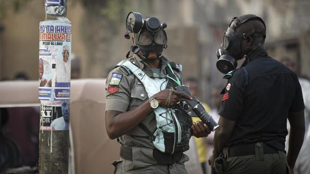 Riot policeman wear gas masks and carry a tear gas grenade launcher, but did not fire, during a celebratory gathering of supporters of President Muhammadu Buhari anticipating victory, in Kano, northern Nigeria. (Ben Curtis / AP) Riot policeman wear gas masks and carry a tear gas grenade launcher, but did not fire, during a celebratory gathering of supporters of President Muhammadu Buhari anticipating victory, in Kano, northern Nigeria. (Ben Curtis / AP)