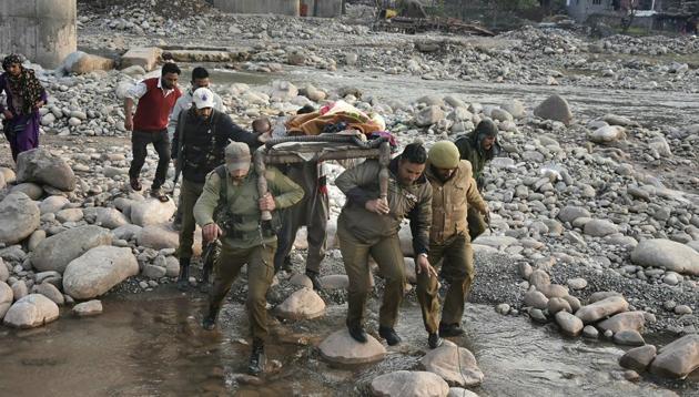 Police and locals carry an injured for treatment to a hospital after firing and mortar shelling by the Pakistani Army along the LoC in Krishna Ghati (KG) sector of J&K. (PTI) Police and locals carry an injured for treatment to a hospital after firing and mortar shelling by the Pakistani Army along the LoC in Krishna Ghati (KG) sector of J&K. (PTI)