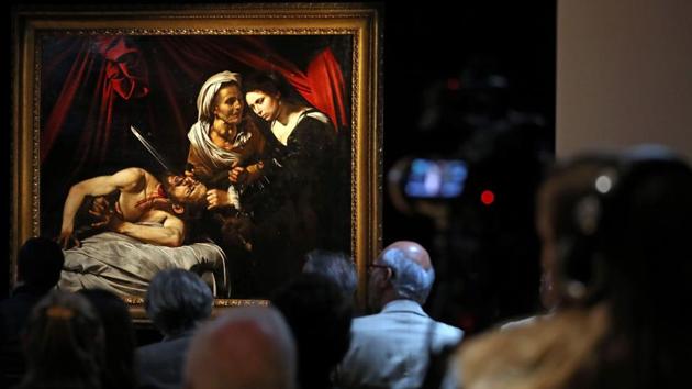 A painting, believed to be the second version of “Judith Beheading Holofernes” by Italian artist Michelangelo Merisi da Caravaggio, is pictured during a photocall in London following its restoration. It is a burst of violence painted in haunting tones by a Renaissance master worth at least $100 million -- or yet another fake distressing the art world. (Daniel Leal-Olivas / AFP) A painting, believed to be the second version of “Judith Beheading Holofernes” by Italian artist Michelangelo Merisi da Caravaggio, is pictured during a photocall in London following its restoration. It is a burst of violence painted in haunting tones by a Renaissance master worth at least $100 million -- or yet another fake distressing the art world. (Daniel Leal-Olivas / AFP)