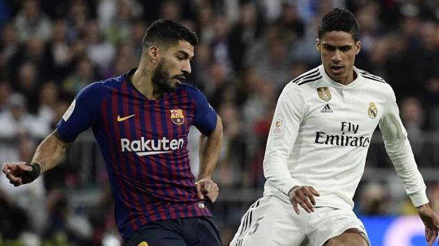 Barcelona's Uruguayan forward Luis Suarez (L) vies with Real Madrid's French defender Raphael Varane during the Spanish Copa del Rey (King's Cup) semi-final second leg.(AFP)