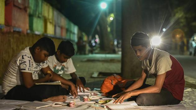Students prepare for SSC Board Exam under street lights at Worli Abhyas Galli in Mumbai, Maharashtra. (Kunal Patil / HT Photo) 