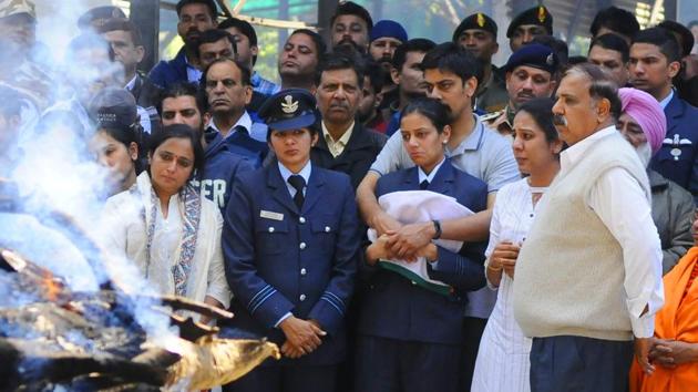 The last rites of squadron leader Siddharth Vashisht, who died in a helicopter crash in Jammu and Kashmir’s Budgam district, were performed in Chandigarh, India with full military honours. In uniform, the deceased officer’s wife, Aarti, who is also a squadron leader, was seen holding the tricolour. (Anil Dayal / HT Photo) 