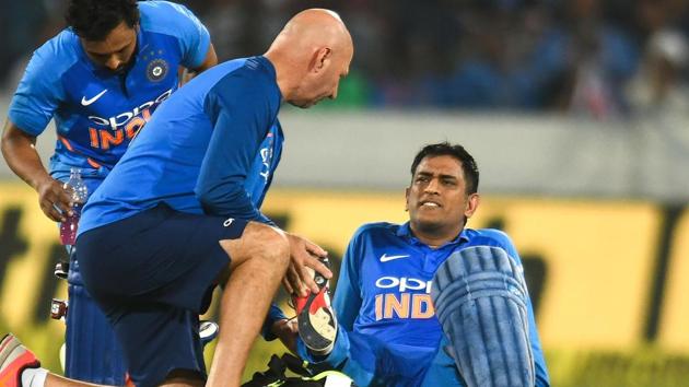 Dhoni is attended to by team physiotherapist. (AFP)
