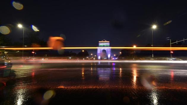 Light trails from cars are seen during a sudden rain, at India Gate, in New Delhi. (Biplov Bhuyan / HT Photo) 
