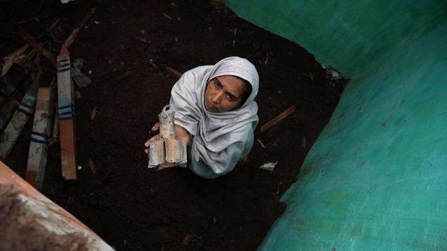 A woman holds a fin of an exploded mortar, that locals say was fired by Pakistani troops, damaging her house in Patri village of Mendhar, Jammu and Kashmir, near the Line of Control border with Pakistan. (Sajjad Hussain / AFP) 