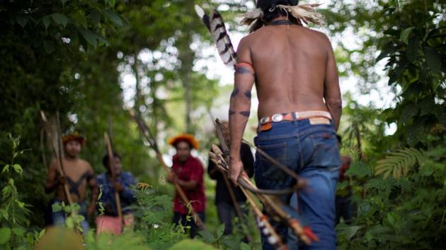 Chiefs and warriors painted their bodies, put on headdresses of macaw fathers and performed a war dance. They wrote a letter pleading for government protection, warning they would resort to their bows and arrows if forced to. “We need this land and its forest trees standing to survive as a people,” Tangae Uru-eu-wau-wau, a village leader, told Reuters. Weeks later, no one has been punished. (Ueslei Marcelino / REUTERS) Chiefs and warriors painted their bodies, put on headdresses of macaw fathers and performed a war dance. They wrote a letter pleading for government protection, warning they would resort to their bows and arrows if forced to. “We need this land and its forest trees standing to survive as a people,” Tangae Uru-eu-wau-wau, a village leader, told Reuters. Weeks later, no one has been punished. (Ueslei Marcelino / REUTERS)