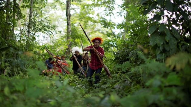 A tense stand-off ensued with members of the Uru-eu-wau-wau tribe, who captured the January confrontation on a cellphone video viewed by Reuters. The trespassers threatened to set fire to their villages to drive them out, tribal members said. Tribesmen readied poison-tipped arrows in their bows. (Ueslei Marcelino / REUTERS) A tense stand-off ensued with members of the Uru-eu-wau-wau tribe, who captured the January confrontation on a cellphone video viewed by Reuters. The trespassers threatened to set fire to their villages to drive them out, tribal members said. Tribesmen readied poison-tipped arrows in their bows. (Ueslei Marcelino / REUTERS)
