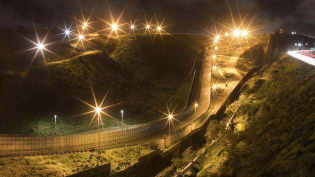 A US border barrier and secondary fence are seen from Tijuana, Mexico. But when the sisters arrived in Tijuana, they heard from family back home in El Salvador that their father had crossed the border and ended up deported. They now are unsure of where to go. (Emilio Espejel / AP) A US border barrier and secondary fence are seen from Tijuana, Mexico. But when the sisters arrived in Tijuana, they heard from family back home in El Salvador that their father had crossed the border and ended up deported. They now are unsure of where to go. (Emilio Espejel / AP)