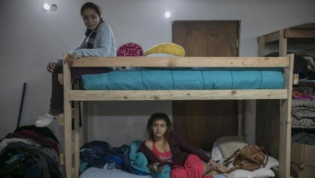 Xiomara Henriquez Ayala sits atop the bunk bed she shares with 18-year-old Valeria Ramos of Honduras, at the Agape World Mission shelter. The sisters fear being deported to El Salvador, though their parents are there. Back home, gang members had beaten up their father and threatened them for walking into what they consider the gang’s territory on their way to school. (Emilio Espejel / AP) Xiomara Henriquez Ayala sits atop the bunk bed she shares with 18-year-old Valeria Ramos of Honduras, at the Agape World Mission shelter. The sisters fear being deported to El Salvador, though their parents are there. Back home, gang members had beaten up their father and threatened them for walking into what they consider the gang’s territory on their way to school. (Emilio Espejel / AP)
