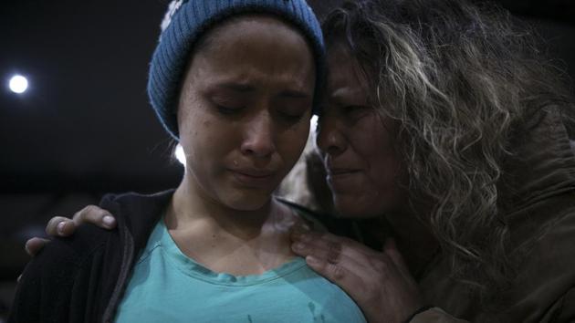Milagro is comforted by a local church member during a religious service. Pastor Albert Rivera said he is working with the Salvadoran consulate to get the girls’ birth certificates so they can apply for asylum in Mexcio, attend school and find part-time work. He also is trying to get their mother a Mexican visa so she can come to Tijuana. A San Diego woman has offered to pay for the mother’s plane ticket. (Emilio Espejel / AP) Milagro is comforted by a local church member during a religious service. Pastor Albert Rivera said he is working with the Salvadoran consulate to get the girls’ birth certificates so they can apply for asylum in Mexcio, attend school and find part-time work. He also is trying to get their mother a Mexican visa so she can come to Tijuana. A San Diego woman has offered to pay for the mother’s plane ticket. (Emilio Espejel / AP)