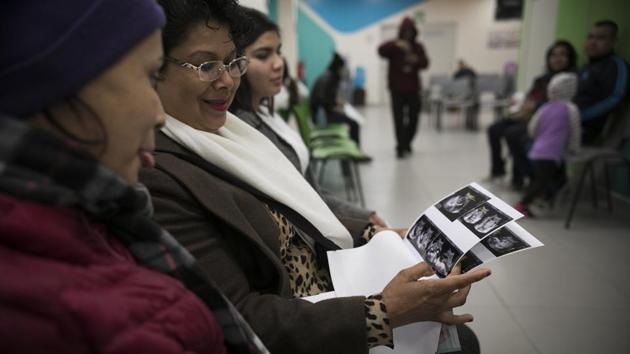 Milagro de Jesus Henriquez Ayala (L), shows her ultrasound scans to Sister Cristina of Agape World Mission. Milagro would like her mother there for when she gives birth. “I never thought I would be a mother so young,” Milagro said. “But it’s Ok. I’ll give him love. That’s all one needs.” (Emilio Espejel / AP) Milagro de Jesus Henriquez Ayala (L), shows her ultrasound scans to Sister Cristina of Agape World Mission. Milagro would like her mother there for when she gives birth. “I never thought I would be a mother so young,” Milagro said. “But it’s Ok. I’ll give him love. That’s all one needs.” (Emilio Espejel / AP)