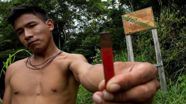 The invaders retreated. But a bullet-riddled sign at the entrance to their sprawling reservation now serves as their calling card. The placard is emblazoned with the acronym FUNAI, a federal agency charged with protecting indigenous land rights. “It was a warning that they are coming back,” Awip Puré Uru-eu-wau-wau, a 19-year-old tribal member, told Reuters. (Ueslei Marcelino / REUTERS) The invaders retreated. But a bullet-riddled sign at the entrance to their sprawling reservation now serves as their calling card. The placard is emblazoned with the acronym FUNAI, a federal agency charged with protecting indigenous land rights. “It was a warning that they are coming back,” Awip Puré Uru-eu-wau-wau, a 19-year-old tribal member, told Reuters. (Ueslei Marcelino / REUTERS)