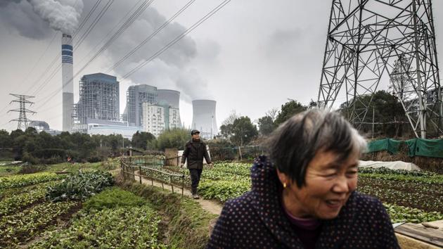 People walk past vegetables growing in a field as emissions rise from cooling towers at a coal-fired power station in Tongling. Downward pressure on the Chinese economy continues to increase, growth in consumption is slowing and growth in effective investment lacks momentum, Li said, outlining the reasons for China’s downward trend from the heyday of double digit growth in 2010. (Qilai Shen / Bloomberg) People walk past vegetables growing in a field as emissions rise from cooling towers at a coal-fired power station in Tongling. Downward pressure on the Chinese economy continues to increase, growth in consumption is slowing and growth in effective investment lacks momentum, Li said, outlining the reasons for China’s downward trend from the heyday of double digit growth in 2010. (Qilai Shen / Bloomberg)