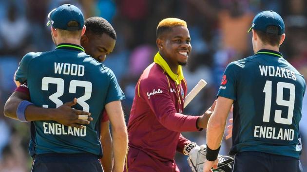 Mark Wood (L) and Chris Woakes (R) of England congratulate Darren Bravo (2L) and Shimron Hetmyer (2R) .(AFP)