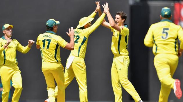 Australian cricketer Pat Cummins (R) celebrates with teammates after taking the wicket of Indian batsman Rohit Sharma. (AFP) Australian cricketer Pat Cummins (R) celebrates with teammates after taking the wicket of Indian batsman Rohit Sharma. (AFP)
