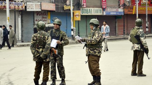 CRPF Personnel stand guard in front of closed market during strike in Srinagar on Tuesday.(Imran Nissar)