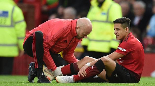 Manchester United's Chilean striker Alexis Sanchez (right) receives medical attention after picking up an injury during the English Premier League match between Manchester United and Southampton.(AFP)
