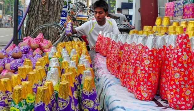 A shopkeeper arranges locally manufactured green fire-crackers to sell for Diwali festival.(PTI file photo)