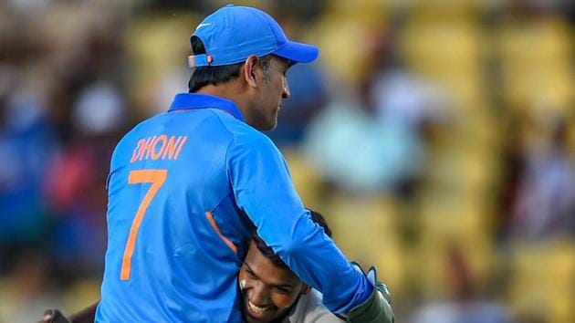 Nagpur: India's MS Dhoni accepts greetings from a pitch-invader during the 2nd ODI cricket match against Australia at Vidarbha Cricket Association Stadium in Nagpur.(PTI)