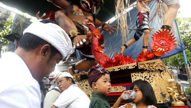 Balinese people sit in front of a giant effigy locally known as "ogoh-ogoh" that represents evil spirits to celebrate Nyepi, the annual day of silence marking Balinese Hindu new year. (AP Photo) Balinese people sit in front of a giant effigy locally known as "ogoh-ogoh" that represents evil spirits to celebrate Nyepi, the annual day of silence marking Balinese Hindu new year. (AP Photo)