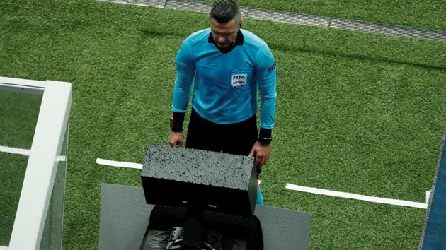 Referee Damir Skomina reviews an incident on VAR before awarding a penalty to Manchester United against PSG on Wednesday.(REUTERS)