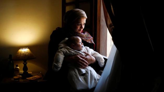 Nahla Mohamed Abdel Rahman, a professor of applied arts, holds her three-month-old baby Younis, in her first week back at work, in Cairo, Egypt. By Egyptian law, mothers can take between three and four months off paid maternity leave, and up to two years unpaid leave. Fathers cannot take any paternity leave. Nahla goes to work five days a week and her sister takes care of her baby as nurseries are too expensive for her. (Hayam Adel / REUTERS) Nahla Mohamed Abdel Rahman, a professor of applied arts, holds her three-month-old baby Younis, in her first week back at work, in Cairo, Egypt. By Egyptian law, mothers can take between three and four months off paid maternity leave, and up to two years unpaid leave. Fathers cannot take any paternity leave. Nahla goes to work five days a week and her sister takes care of her baby as nurseries are too expensive for her. (Hayam Adel / REUTERS)
