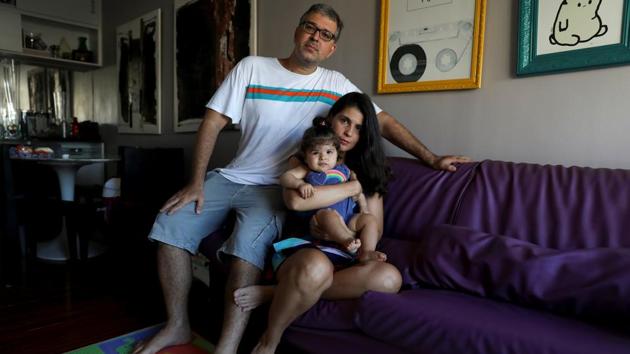 Tatiana Barcellos, a civil servant, her eight-month-old daughter Alice, and her husband, on the day Tatiana resumed work, in Rio de Janeiro, Brazil. Statutory leave for mothers in the public sector is 120 to 180 days.”I feel anxious and worried that my absence will cause stress to my baby. I think mothers should have at least one year of maternity leave, considering the physical and emotional needs of babies in full development”, she said. (Pilar Olivares / REUTERS) Tatiana Barcellos, a civil servant, her eight-month-old daughter Alice, and her husband, on the day Tatiana resumed work, in Rio de Janeiro, Brazil. Statutory leave for mothers in the public sector is 120 to 180 days.”I feel anxious and worried that my absence will cause stress to my baby. I think mothers should have at least one year of maternity leave, considering the physical and emotional needs of babies in full development”, she said. (Pilar Olivares / REUTERS)