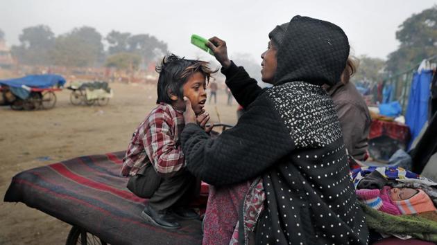 Ruby Khan helps Farmaan get ready for school. The family rarely has more than a few hundred rupees between them. The oldest son Armaan, 17, dropped out of school to try to find work. The middle son Ajmeri, 13, dropped out when he was bullied because of a speech impediment. The oldest daughter Mehendi, 16, often spends her days helping out at a school for homeless children, but earns no pay. (Altaf Qadri / AP) 