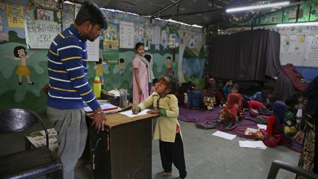 Farmaan studies at Salaam Baalak Trust, an NGO working for street children, in New Delhi. In a family where education was rarely even an afterthought, Farmaan has always loved school. Asked on a recent day what he’d learned in class, he happily listed all his lessons. Then, for good measure, he recited the English alphabet forward and backward. (Altaf Qadri / AP) 