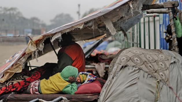 City authorities regularly clear out the squatter camp and often destroy whatever they find. Because of that, some members of the Khan family sleep on a fruit vendor’s cart the size of a large door, with the rest squeezing under a plastic tarp tied to a nearby wall. If the authorities arrive, the family can quickly pile everything they own  onto the cart and roll it away. (Altaf Qadri / AP) 